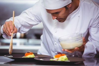 Chef putting sauce on a dish