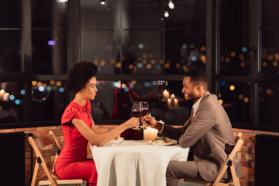 Couple Clinking Glasses Drinking Wine Celebrating Valentine's Day In Restaurant