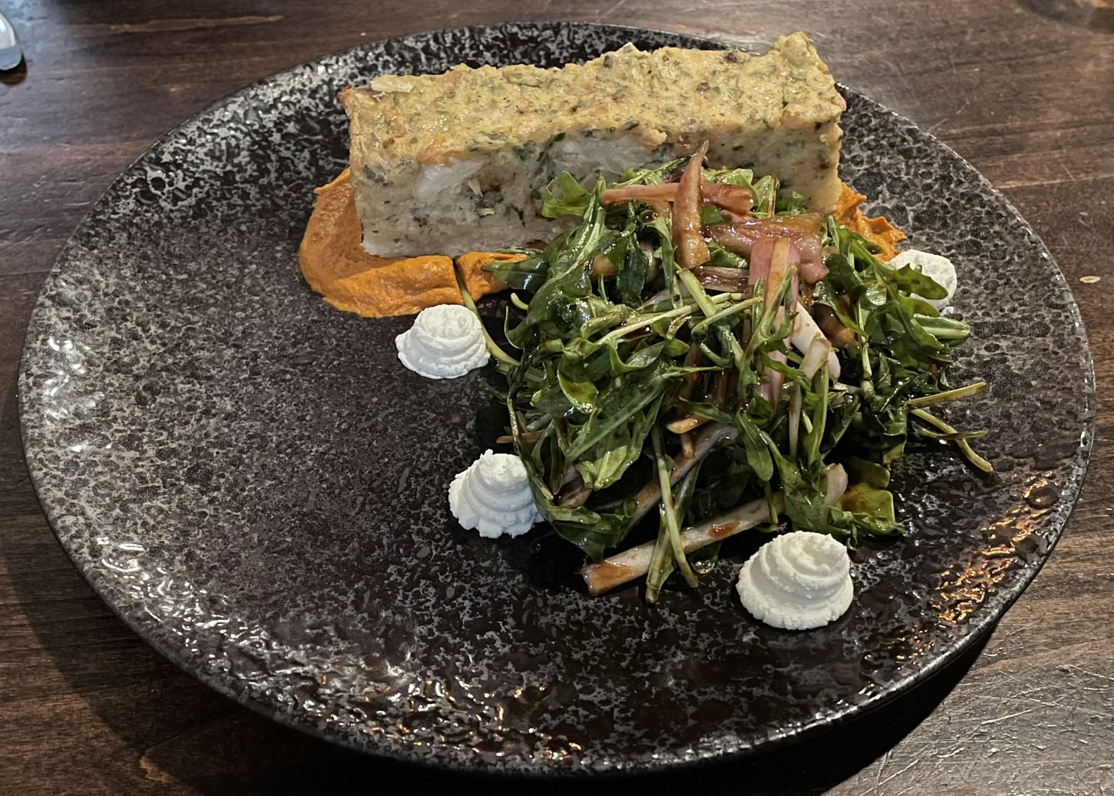 Savory cauliflower tart, almond romesco, arugula salad, and goat cheese mousse at the Block Restaurant