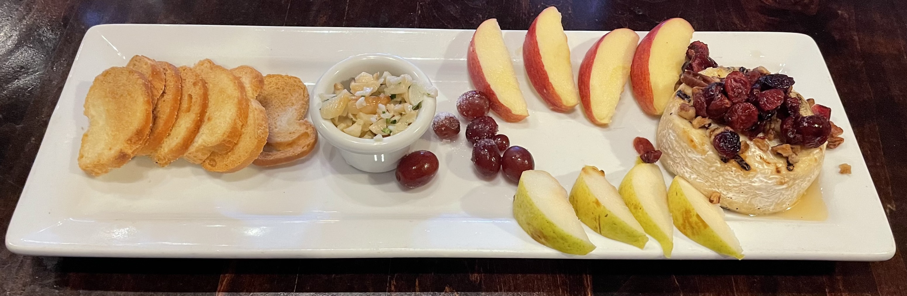 Grilled Brie at Carvers Steak and Seafood restaurant:  cranberries, pears, apples, honey, pecans, sugared grapes, baguettes