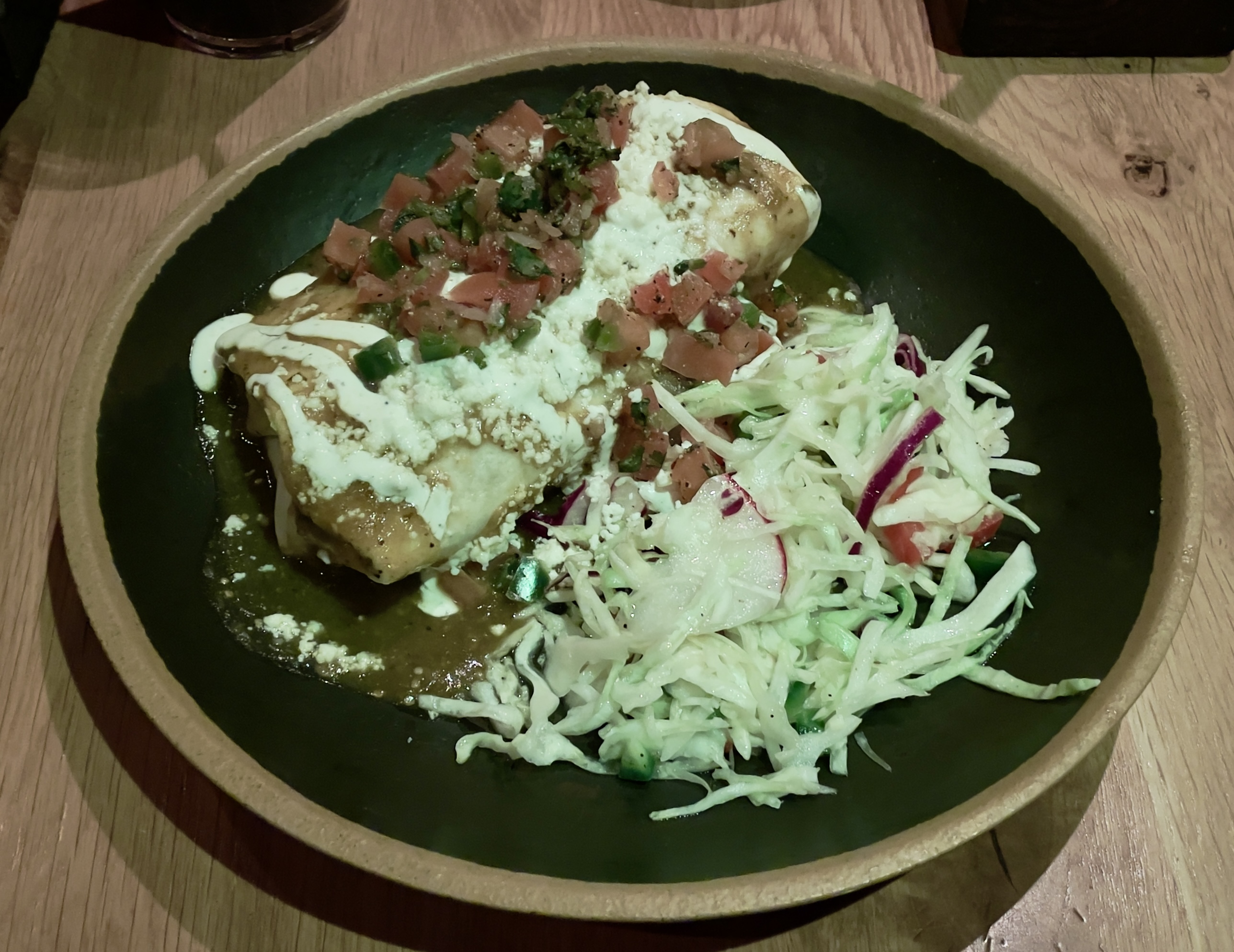 Betty’s Burrito at Casa Bonita.  Tortilla, rice, beans, green chile brisket, Mexican cheese blend, smothered in green chile and topped with pico de gallo, queso fresco, and crema.  Served with cabbage salad.