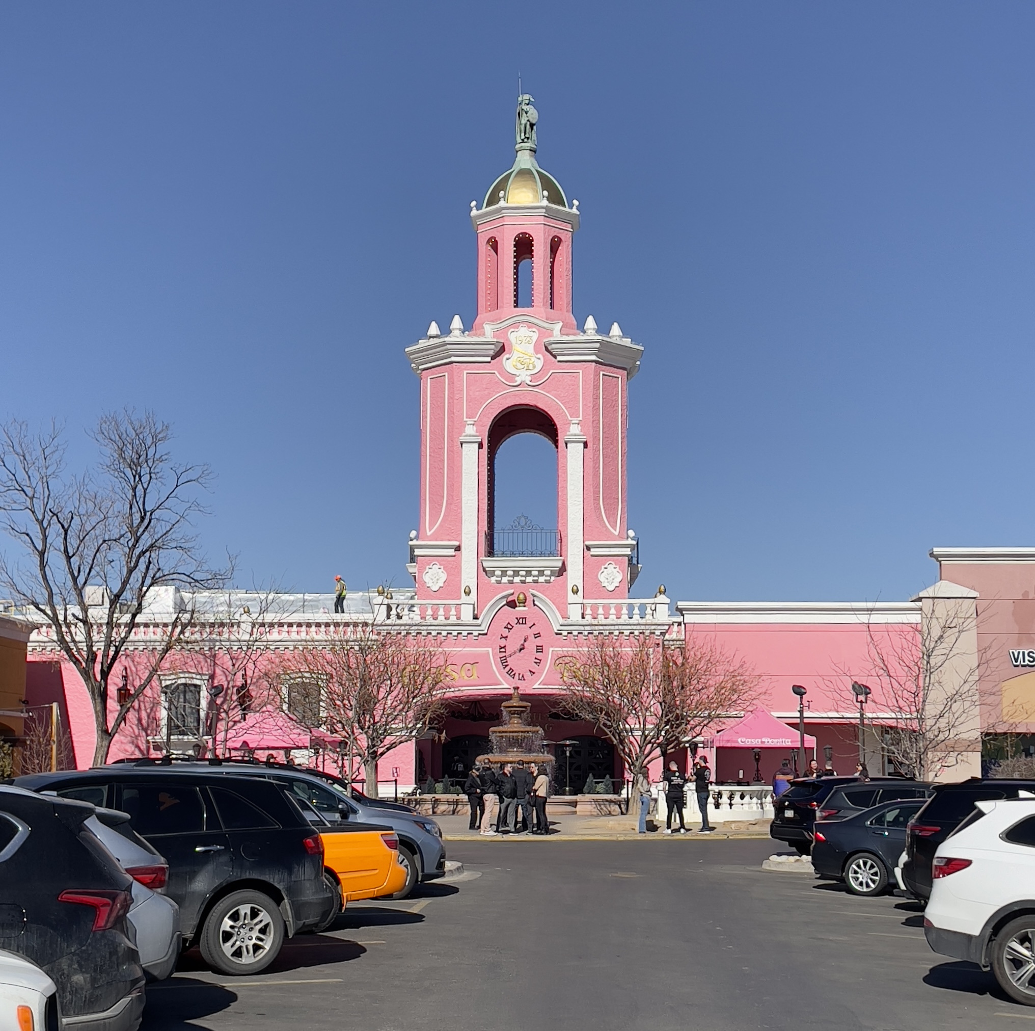 Casa Bonita is a bright pink stucco building with a tall cuppola topped with a statue of Aztec emperor Cuauhtémoc.