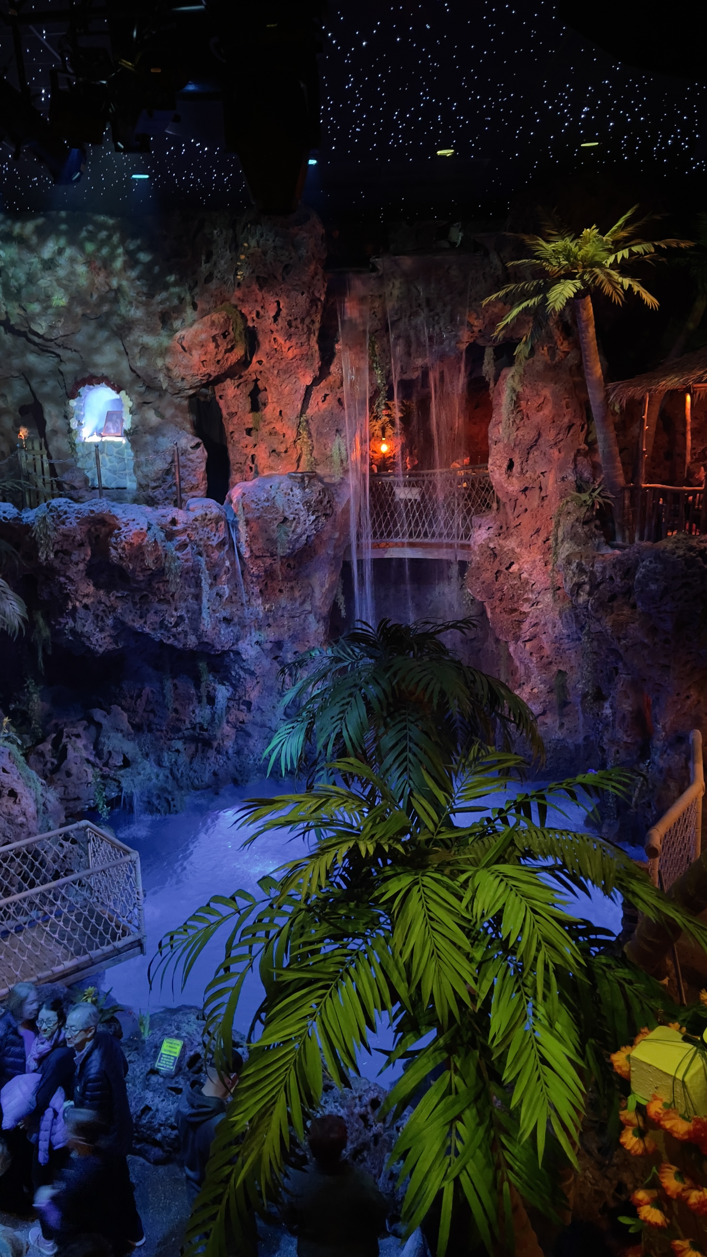 A 30-foot waterfall cascades into a pool at a grotto inside Casa Bonita.