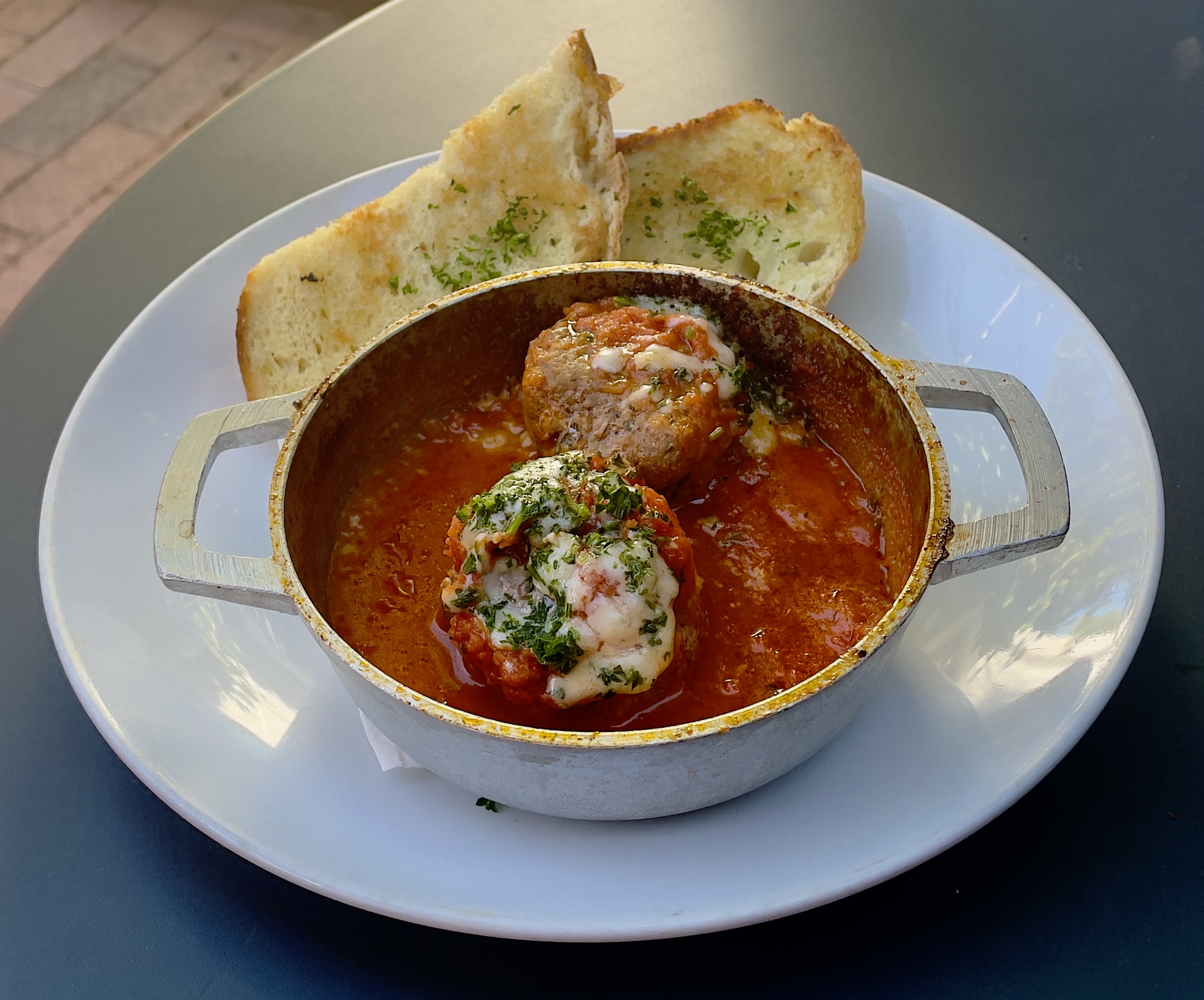 The Albondigas plate at Finca: Beef & pork meatballs, tomato sauce, shaved Manchego, side of crystal bread.