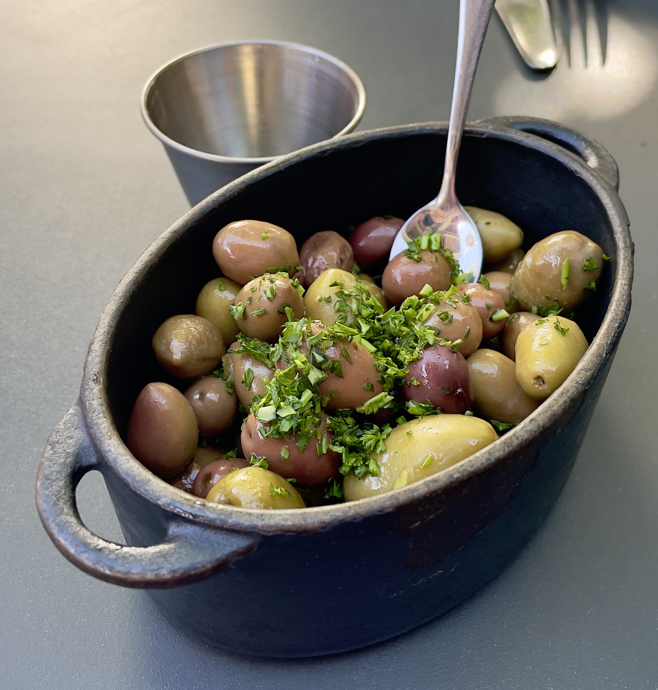 The Olivos plate at Finca: warm olives, citrus, thyme, garlic.