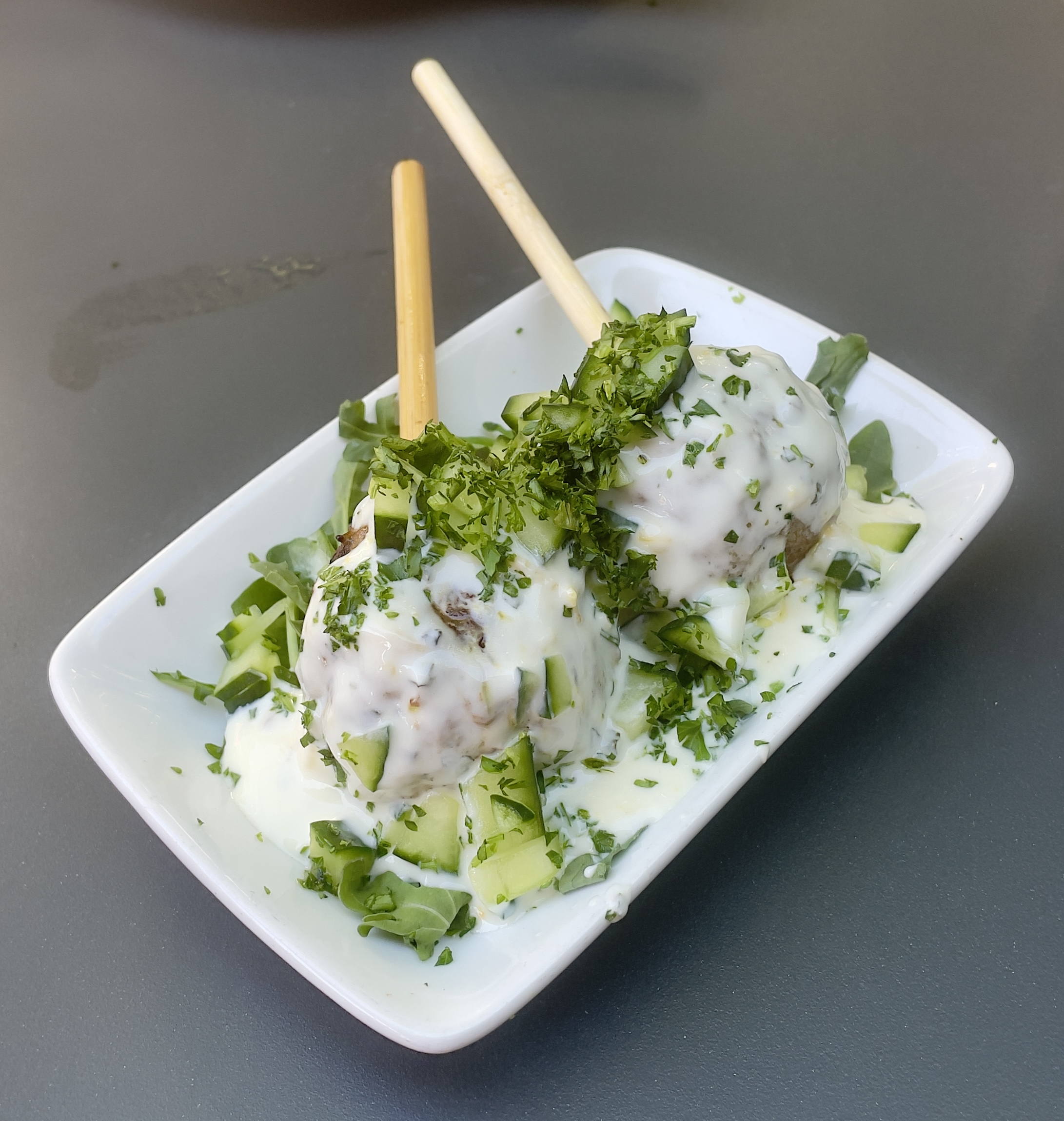 The Pinchos Morunos plate at Finca: Moroccan lamb skewer, yogurt, diced cucumber, fresh herbs.