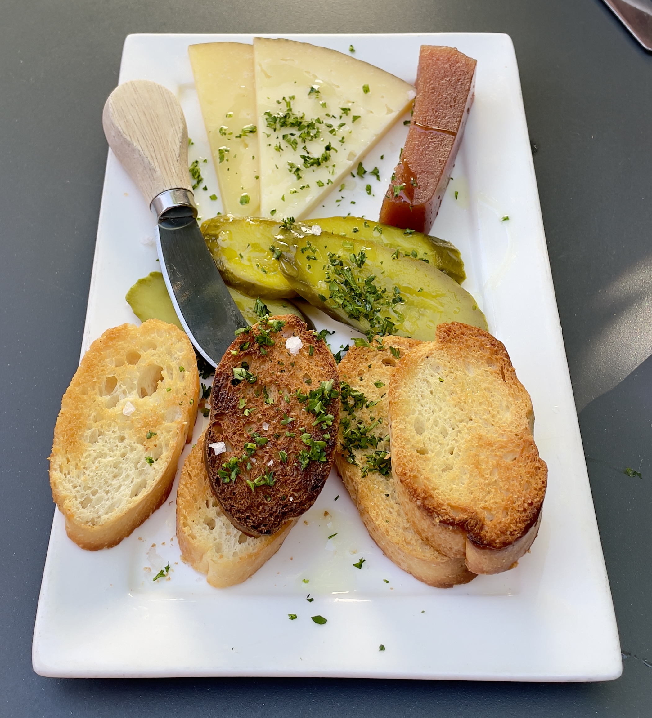 The Plato de Queso plate at Finca: Manchego, membrillo, house pickles, crostini.