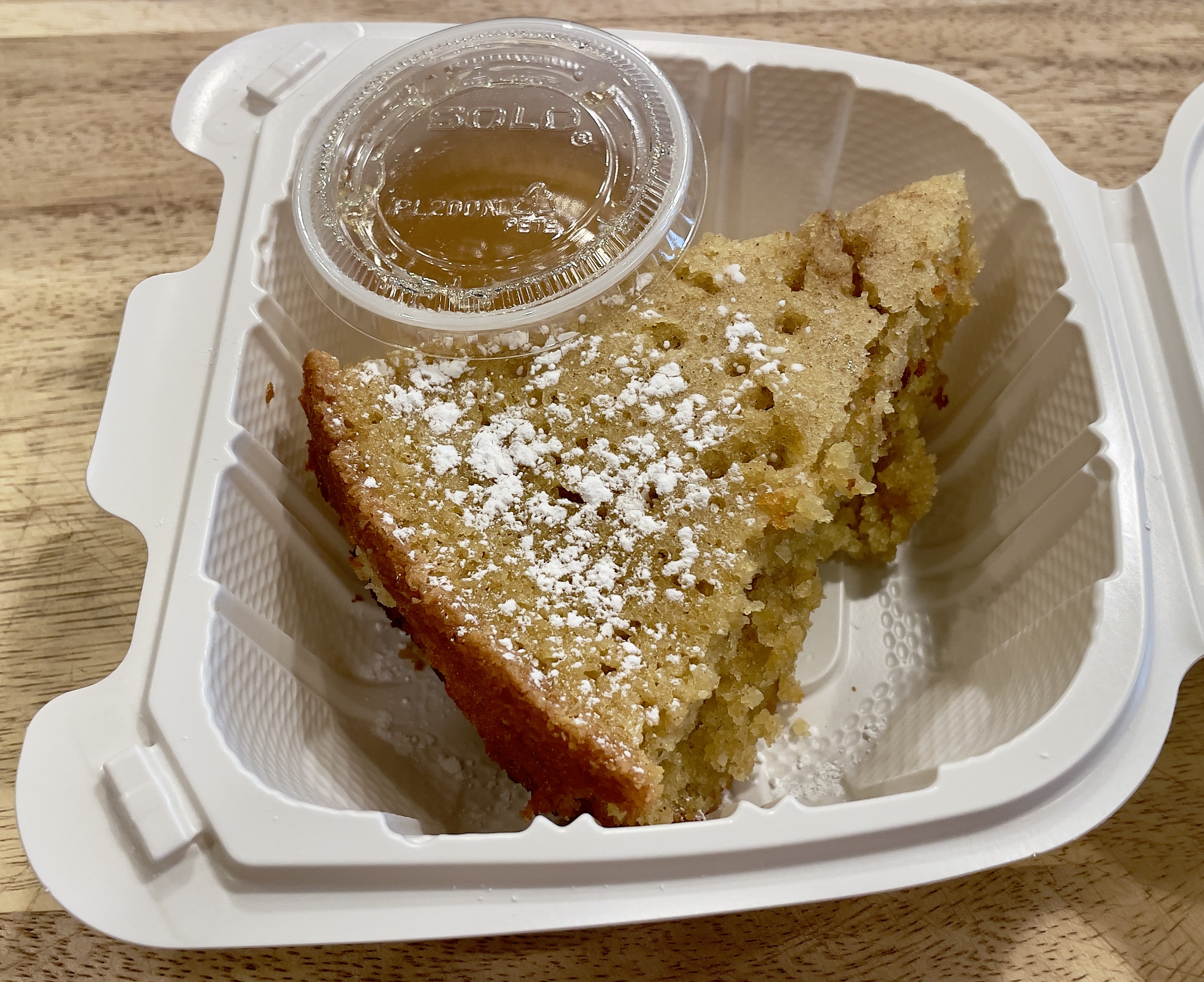 The Torta de Santiago dessert (to-go) from Finca: almond cake with whiskey sauce.
