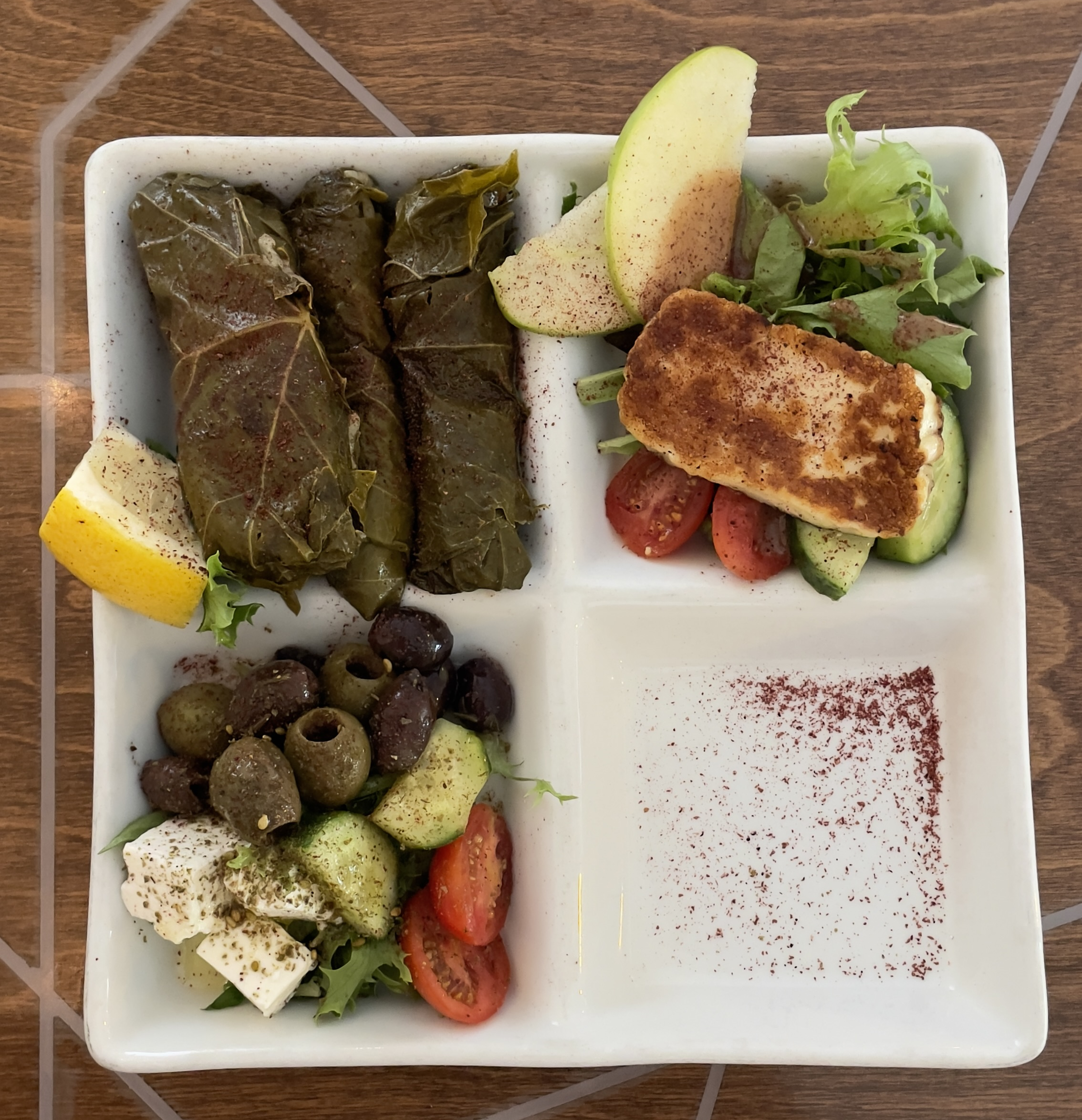 A combination Mezze platter at Layla Mediterranean Grill and Mezze.  Grape Leaves, Halloum Cheese, and Assorted Mediterranean Olives and French Feta Cheese.