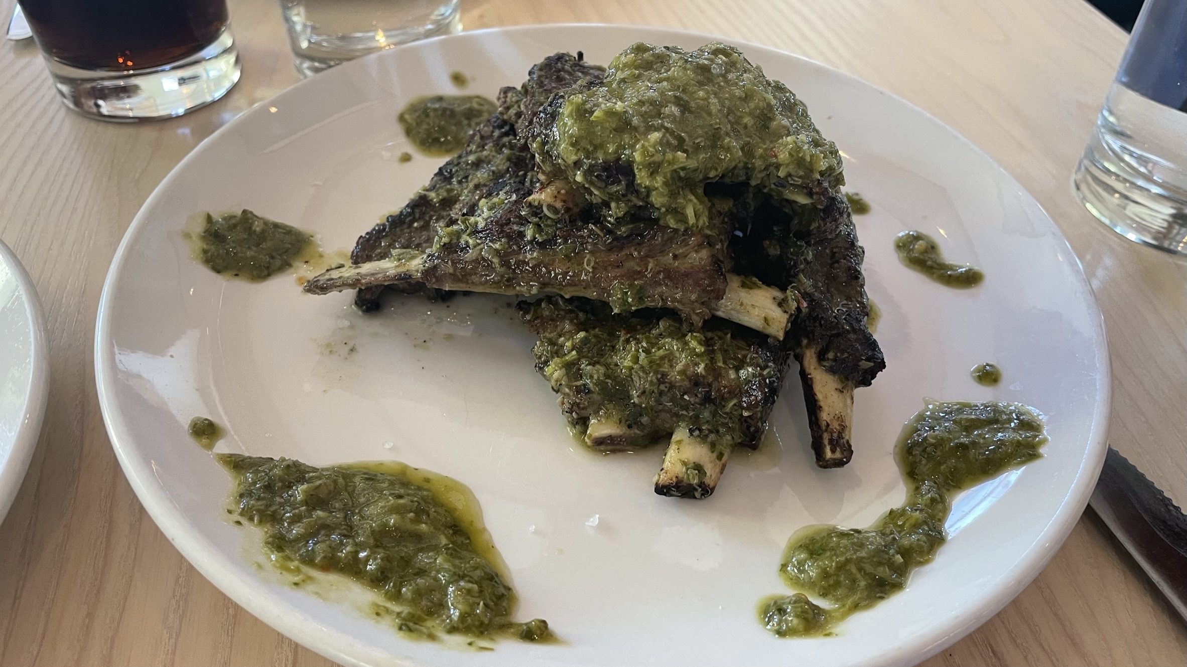 Paidakia (lamb riblets) with chimichurri on a plate