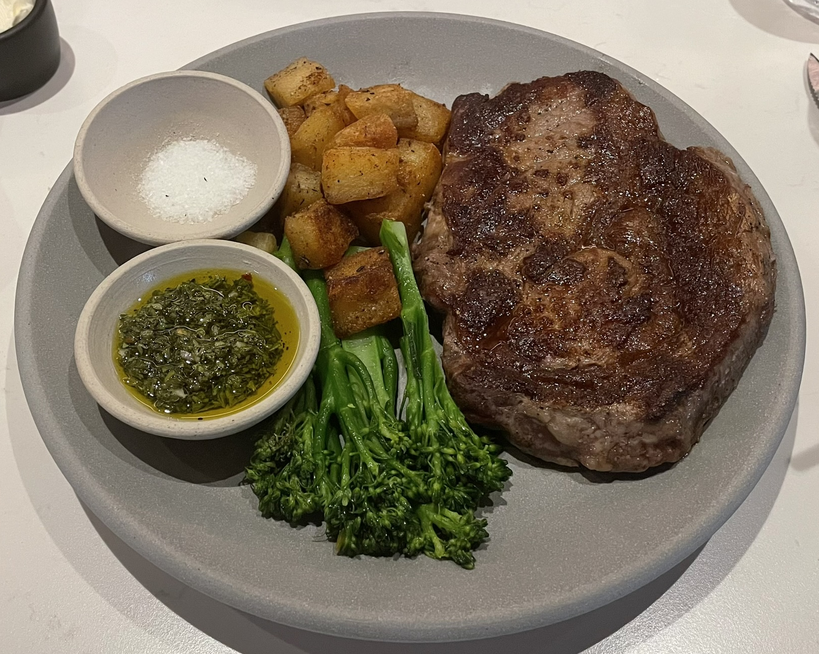 Tagliata:  ribeye, gremolada, broccolini, and crispy potatoes at Matteo Ristorante Italiano