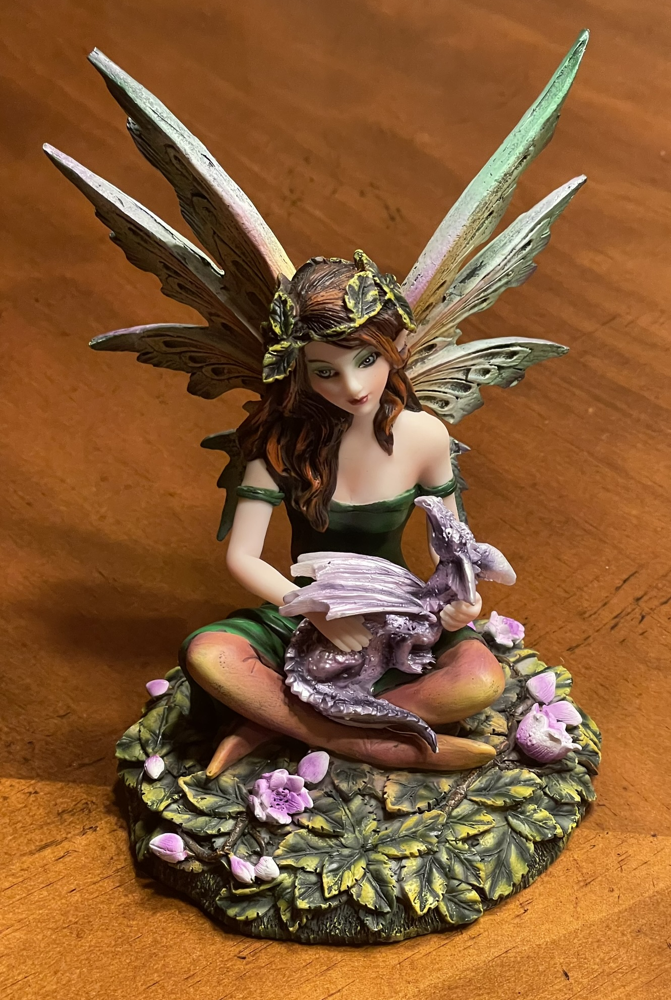 A small statue of a fairy holding a dragon hatchling from Medieval Times in Buena Park, California