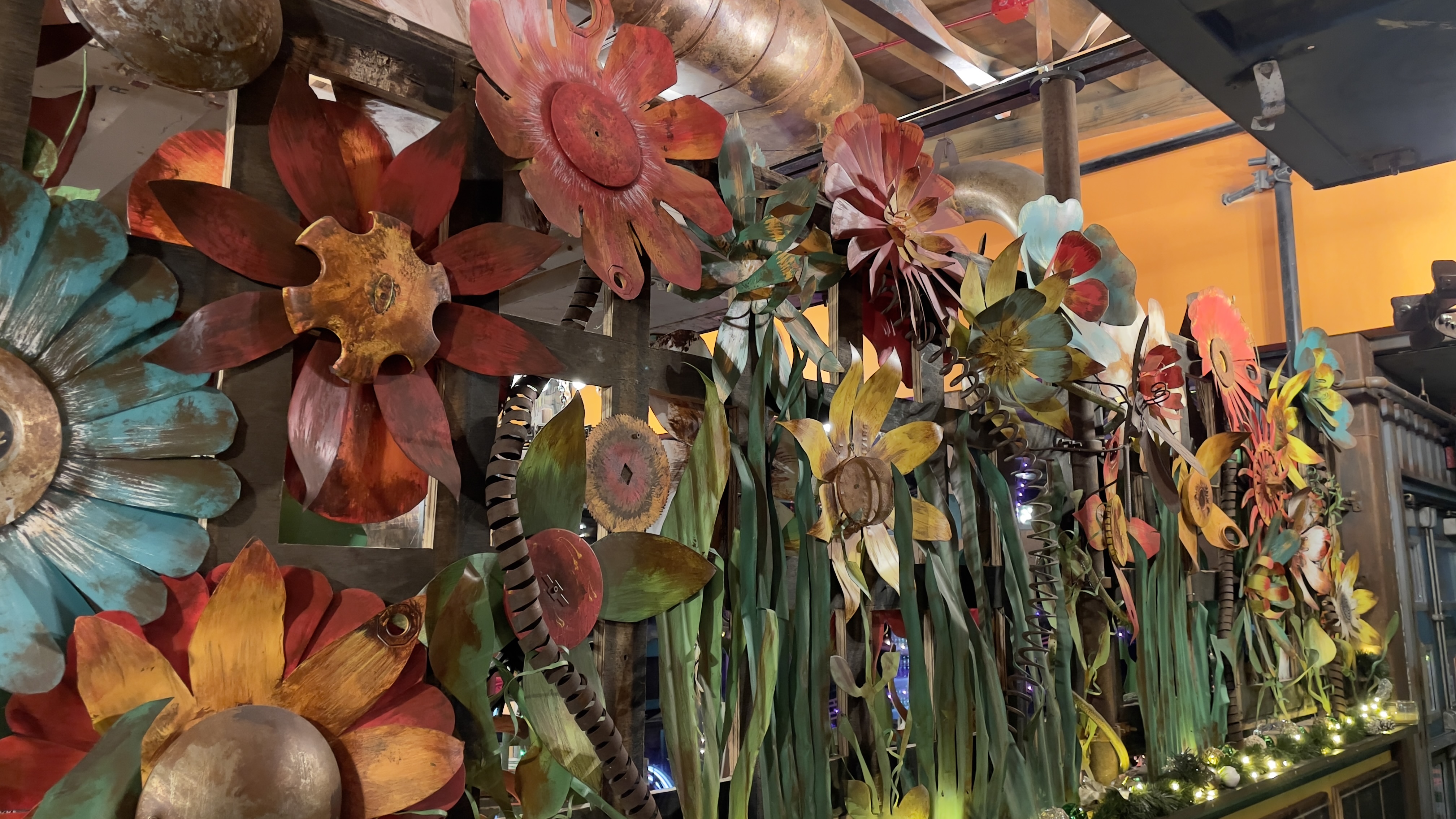 A welded scrap-metal sculpure of flowers at Mi Buena Vida.