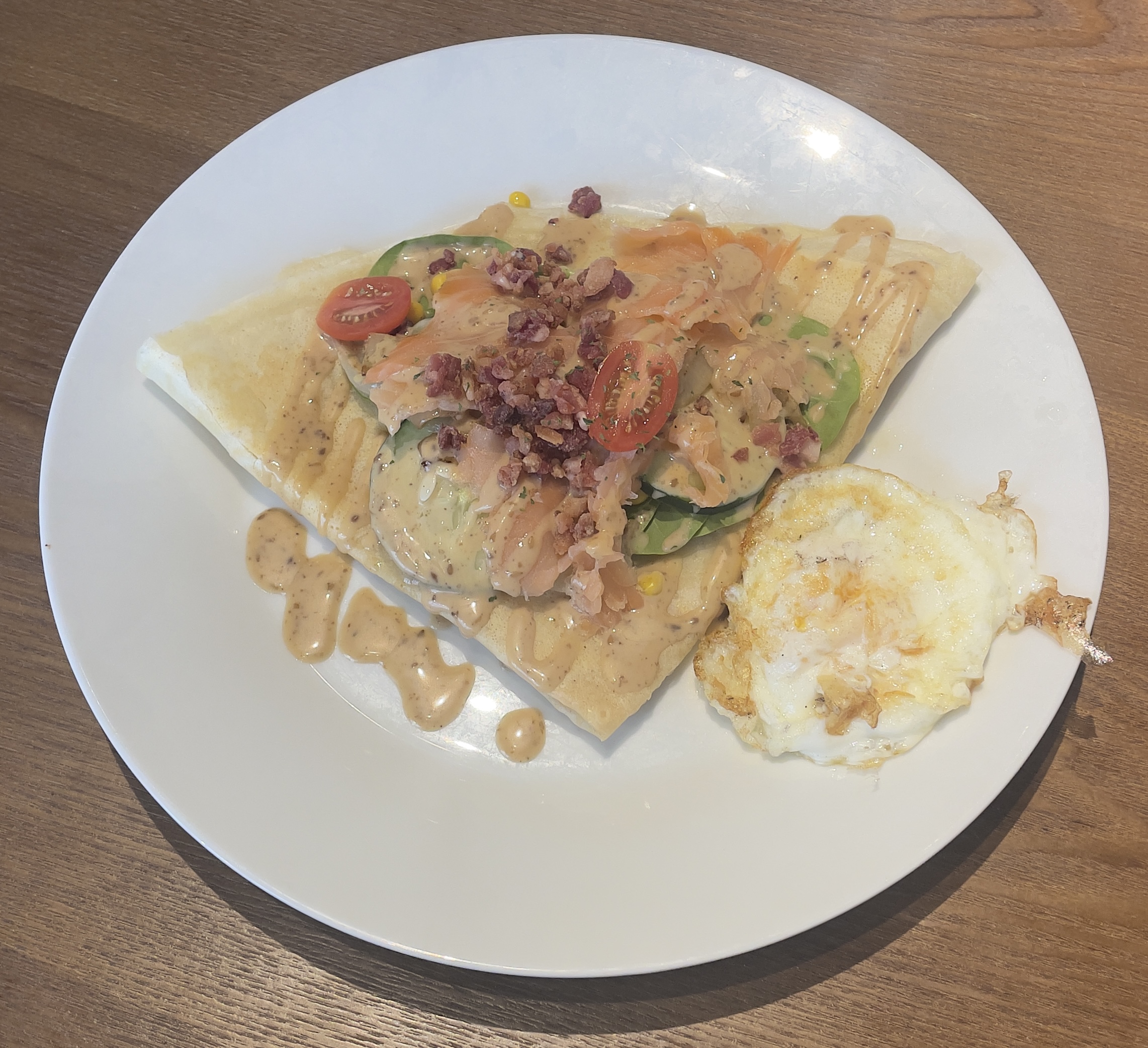 Salmon Oriental Crêpe at MillCrêpes.  Smoked Salmon, Mozzarella Cheese, Spinach, Onions, Cherry Tomatoes, Sweet Corn, Sesame Dressing, Bacon Crumbles, Parsley Flakes.