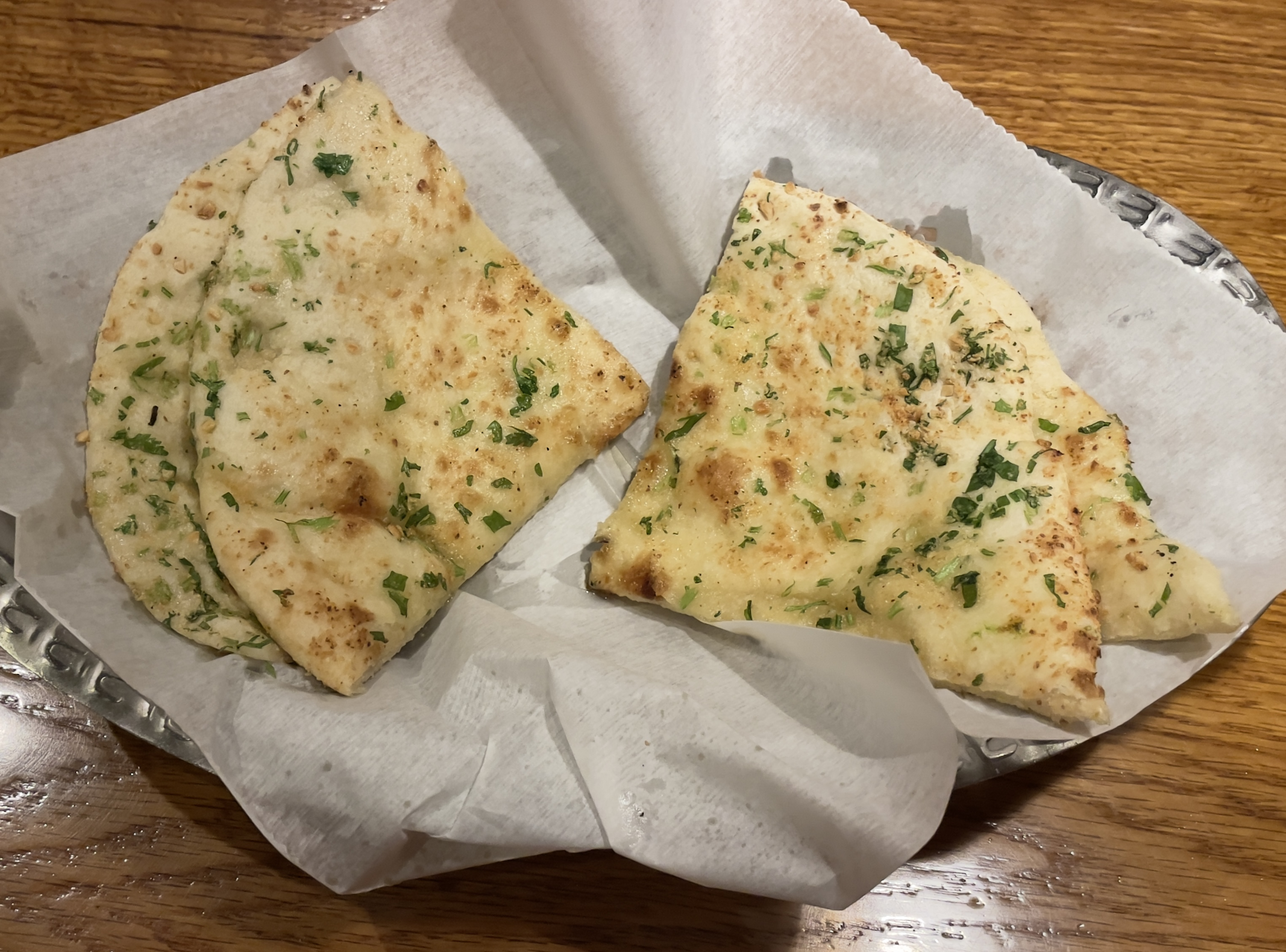 Garlic naan at Mumbai House.  Teardrop-shaped white flat bread with a touch of garlic baked in a tandoor.