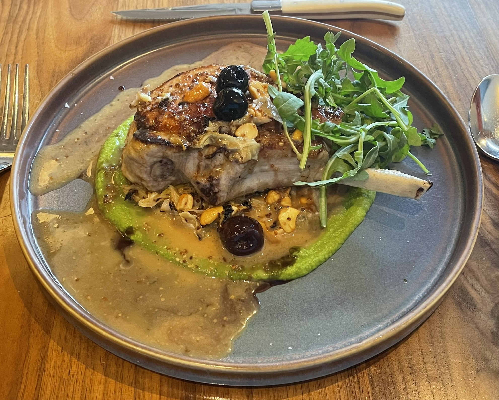 Fennel-Brined Pork Chop at Oquirrh restaurant:  Savoy Cabbage Purée. Cashew, Cherry & Mustard Jus