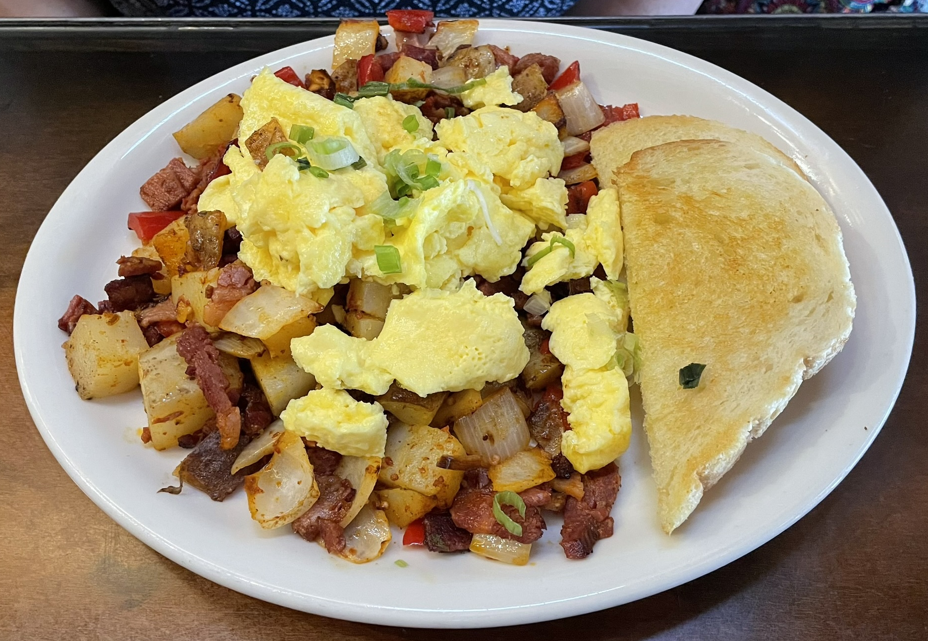 House-made corned beef grilled with potatoes, onions, red peppers, and cheddar & jack.  Topped with two eggs and served with sourdough toast at Piper Down.