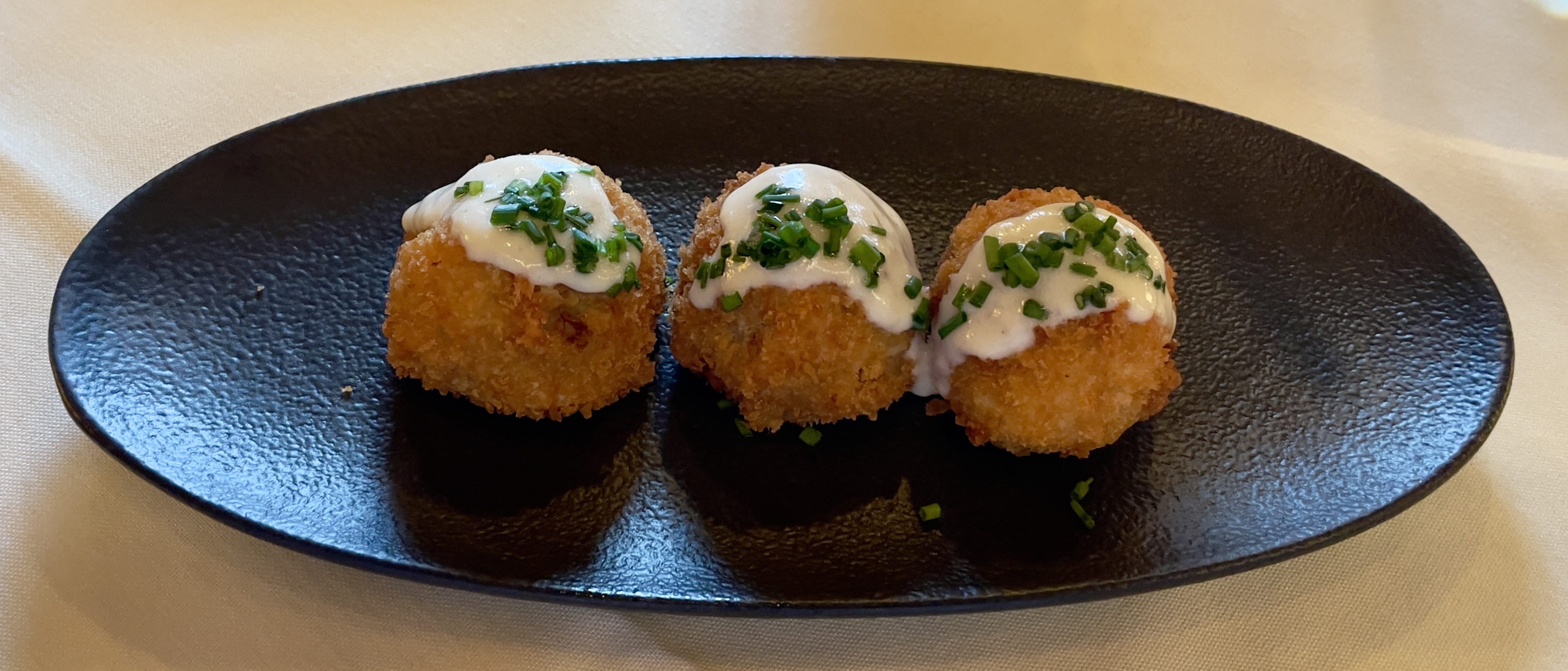 Amuse-bouche at the Tree Room: wild mushroom croquettes with Gruyère Mornay sauce and chives.