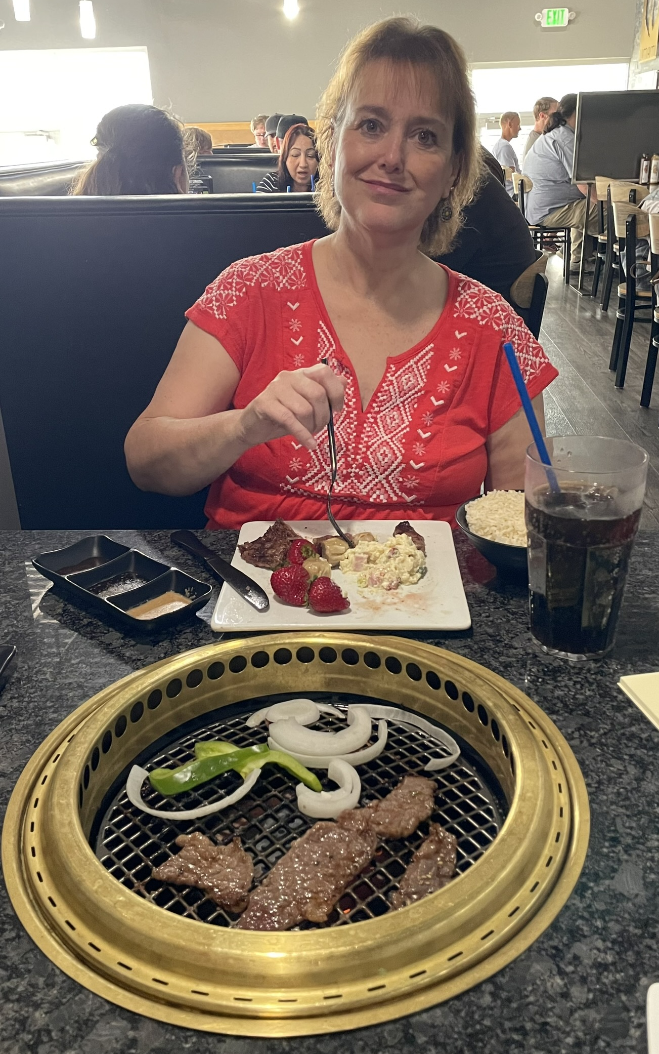 Kathy Hill grilling her own lunch at Umami Japanese Barbecue in Vineyard, Utah.