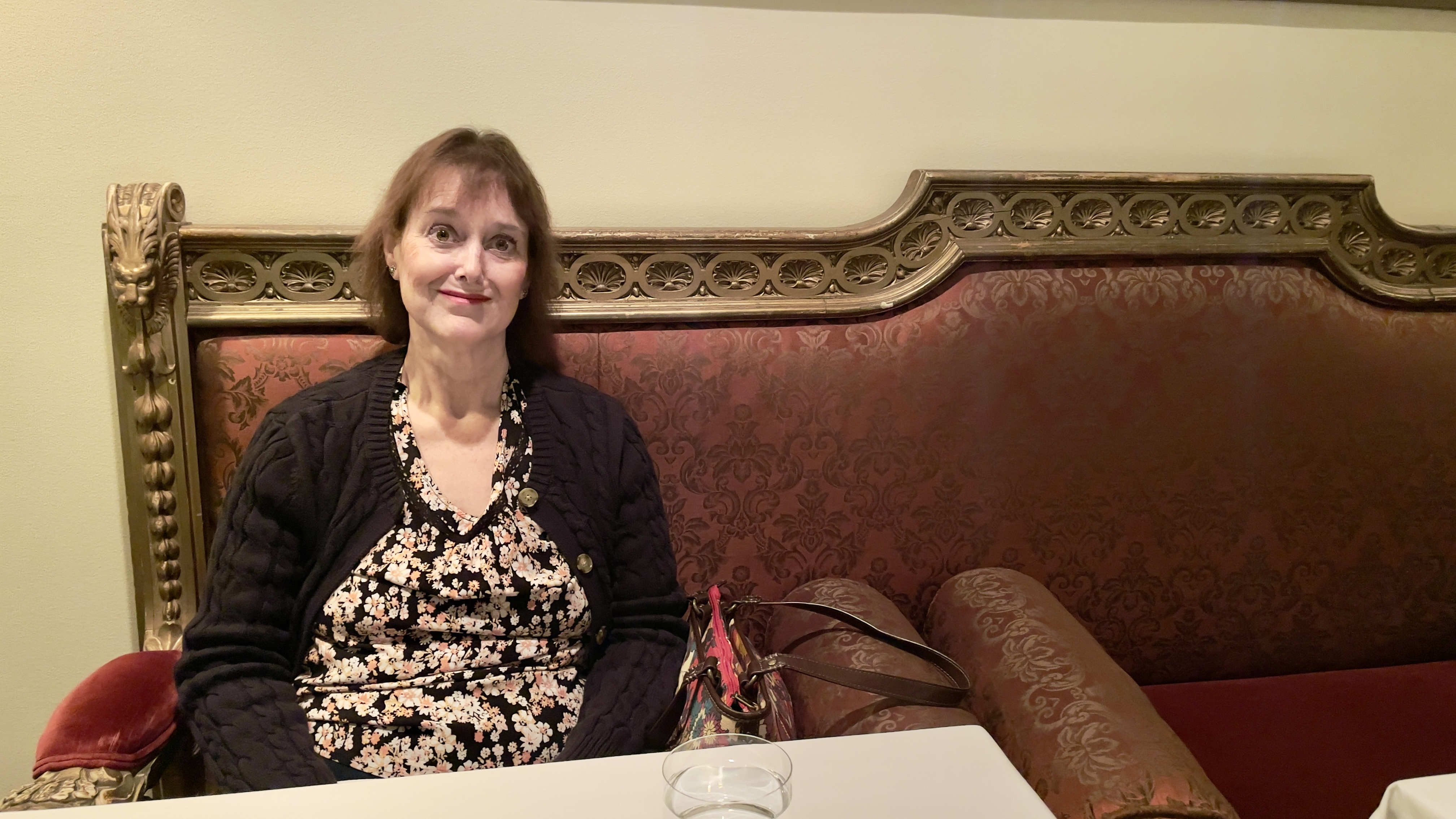 Kathy sits on a centuries-old Italian sofa at Veneto Ristorante Italiano.